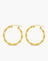 Pair of gold hoop earrings on a white background