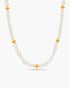 Pearl necklace with gold beads on a white background