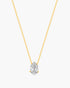 Gold necklace with a clear teardrop-shaped pendant on a white background