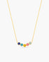 Necklace with colorful round pendants on a gold chain against a white background