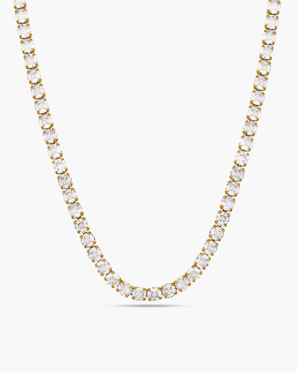 Gold necklace with clear stones on a white background
