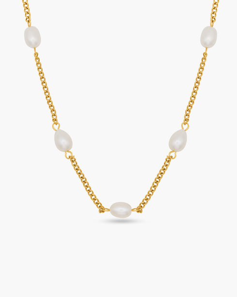 Gold chain necklace with white pearls on a white background
