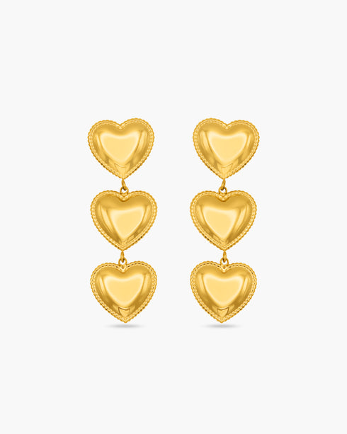 Gold heart-shaped earrings on a white background