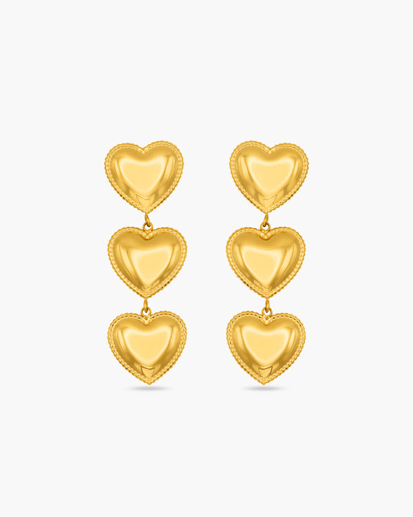 Gold heart-shaped earrings on a white background