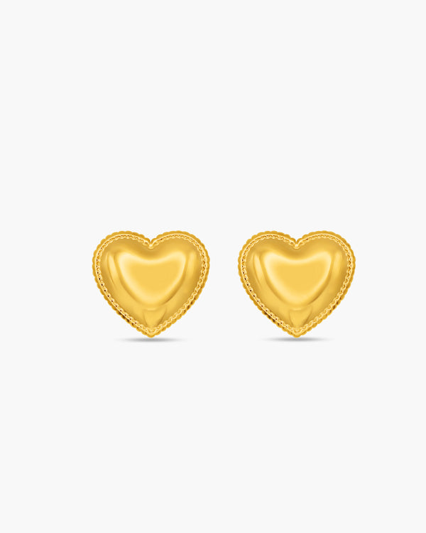 Gold heart-shaped earrings on a white background