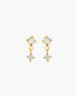 Gold earrings with clear gemstones on a white background