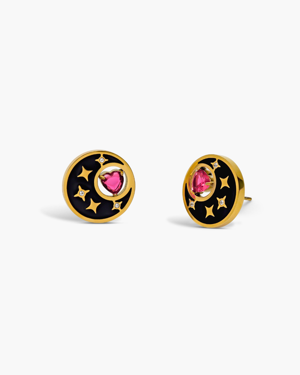 Pair of earrings with black and gold design on a white background