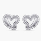 Heart-shaped silver earrings with clear gemstones on a white background