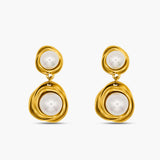 Gold earrings with pearl drops on a white background
