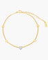 Gold anklet with a heart-shaped diamond on a white background