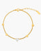 Gold bracelet with heart-shaped diamond on a white background