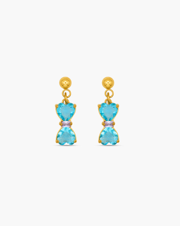 Gold earrings with blue gemstones on a white background