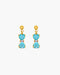 Gold earrings with blue gemstones on a white background