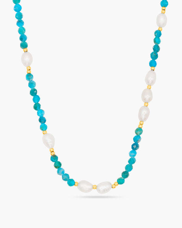 Necklace with turquoise beads and pearls on a white background