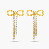 Gold bow-shaped earrings with diamond accents on a white background