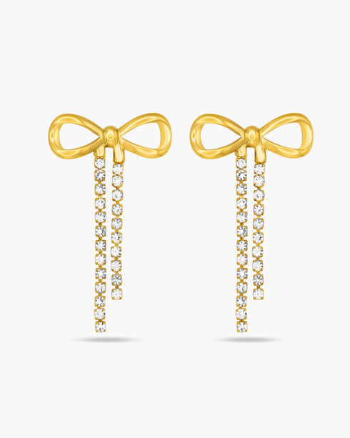 Gold bow-shaped earrings with diamond accents on a white background