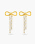 Gold bow-shaped earrings with diamond accents on a white background