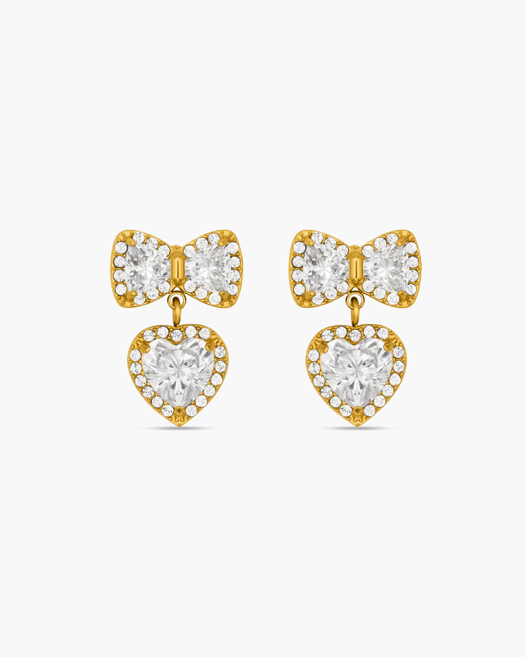 Gold bow-shaped earrings with heart details on a white background