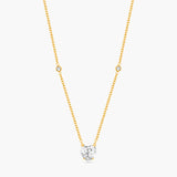 Gold necklace with a diamond pendant on a white background