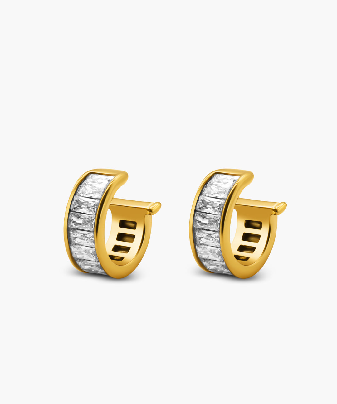Gold hoop earrings with a white stone on a light gray background