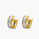 Gold hoop earrings with a white stone on a light gray background