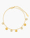 Gold anklet with shell and gemstone charms on a white background