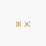 Pair of gold earrings with diamond-like stones on a white background