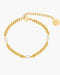 Gold chain bracelet with pearls on a white background