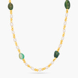 Necklace with green and gold beads on a white background