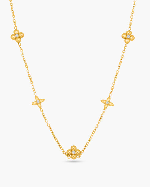 A gold necklace against a white background