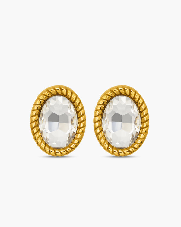 Gold earrings with clear gemstones on a white background