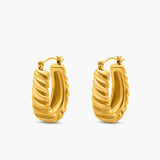 Gold hoop earrings on a white background