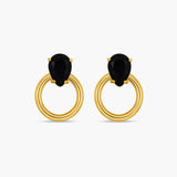 Gold hoop earrings with black gemstones on a white background
