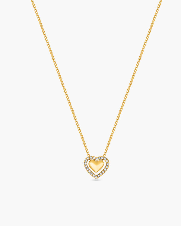 Gold necklace with a heart-shaped pendant on a white background