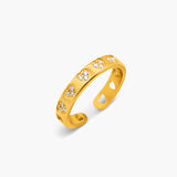 Gold ring with cut-out design on a white background
