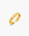 Gold ring with cut-out design on a white background