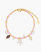Anklet with pink beads, gold accents, and starfish charm on a white background