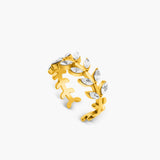 Gold ring with leaf design on a white background