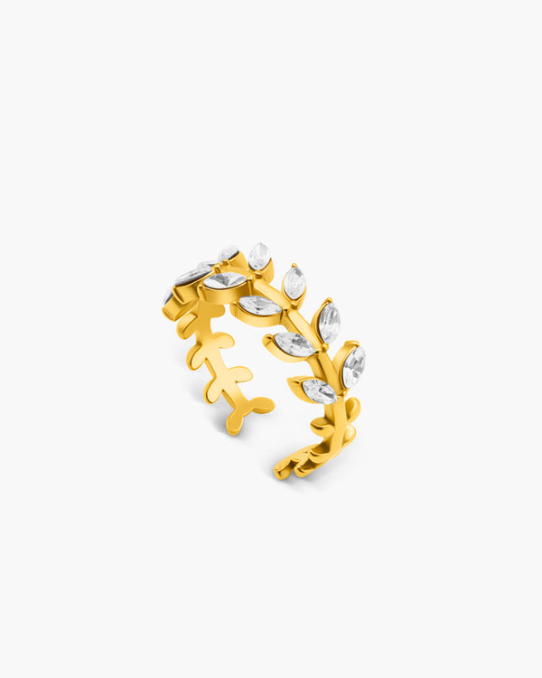 Gold ring with leaf design on a white background