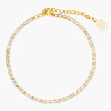 Gold anklet with clear stones on a white background