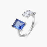 Silver ring with a blue gemstone on a white background