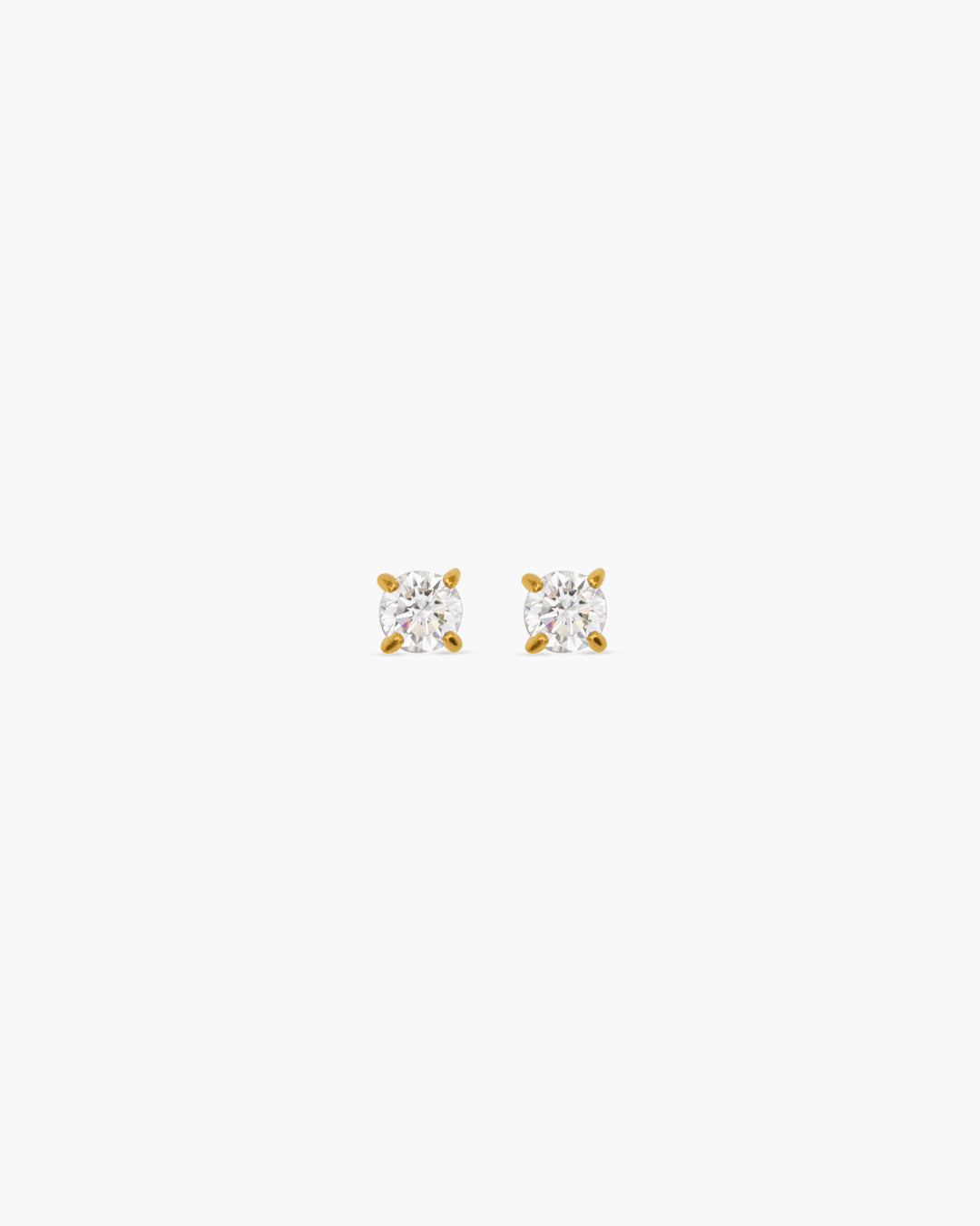 Pair of diamond stud earrings on a white background