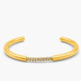 Gold bangle with small stones on a white background
