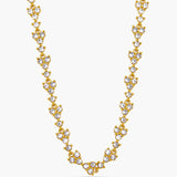 Gold necklace with clear stones on a white background