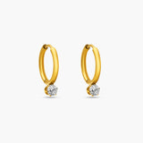 Gold hoop earrings with embedded diamonds on a white background