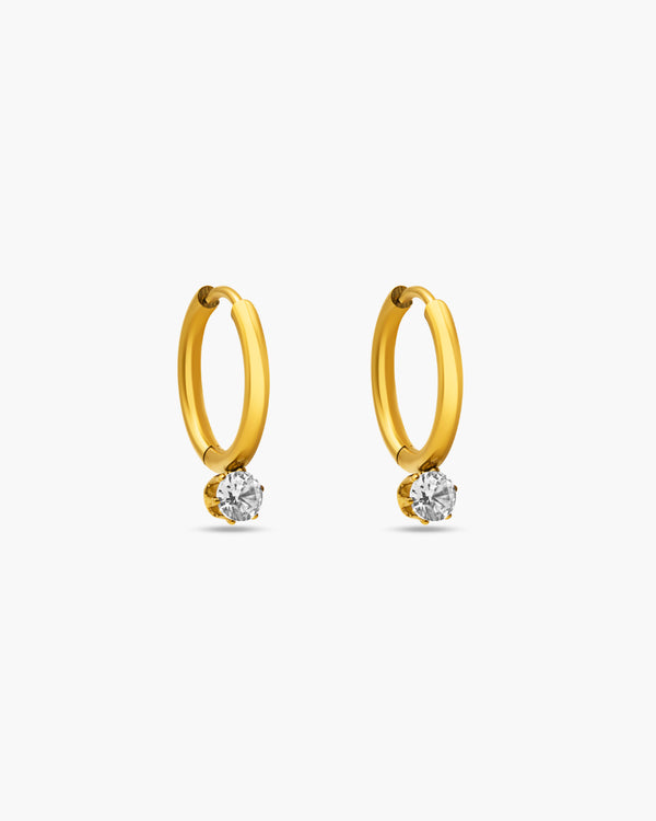 Gold hoop earrings with embedded diamonds on a white background