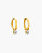 Gold hoop earrings with embedded diamonds on a white background