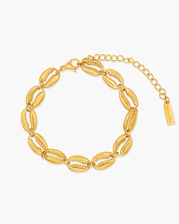 Gold bracelet with shell-like links on a white background