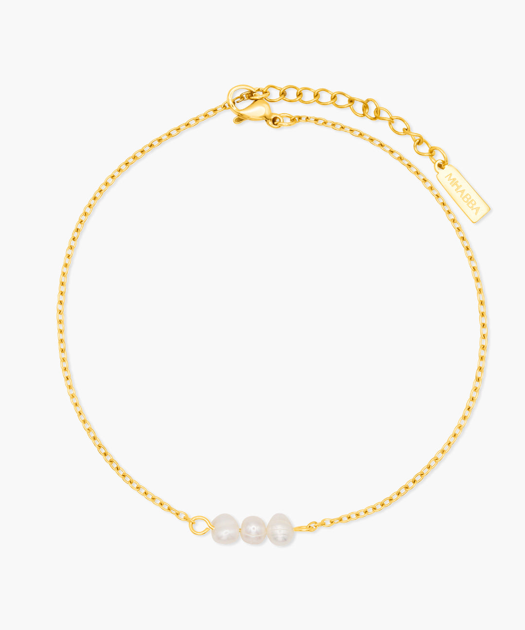 Gold anklet with three pearls on a white background