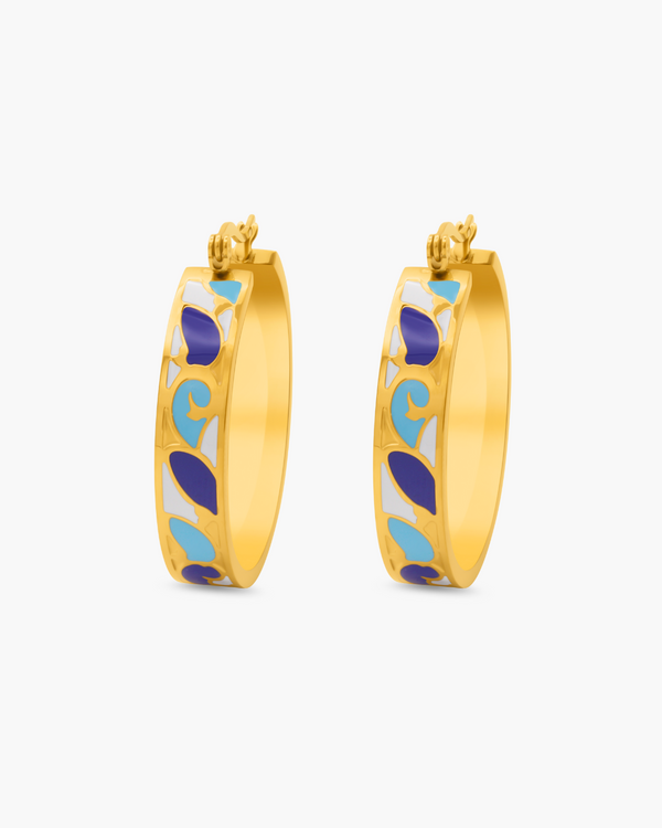 Gold hoop earrings with blue and white pattern on a white background